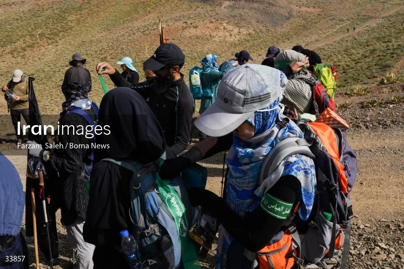 Climbing Tochal Peak with the flag of Imam Hossein (AS)