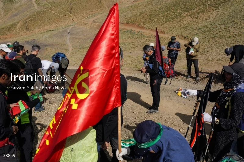 Climbing Tochal Peak with the flag of Imam Hossein (AS)
