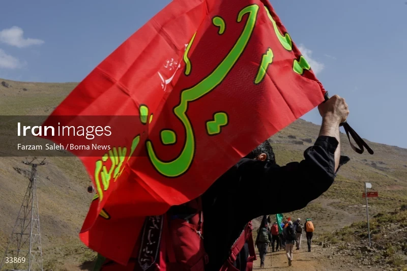 Climbing Tochal Peak with the flag of Imam Hossein (AS)