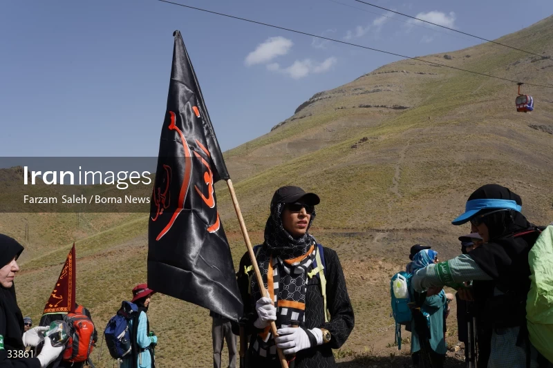 Climbing Tochal Peak with the flag of Imam Hossein (AS)