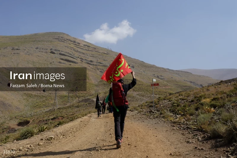 Climbing Tochal Peak with the flag of Imam Hossein (AS)